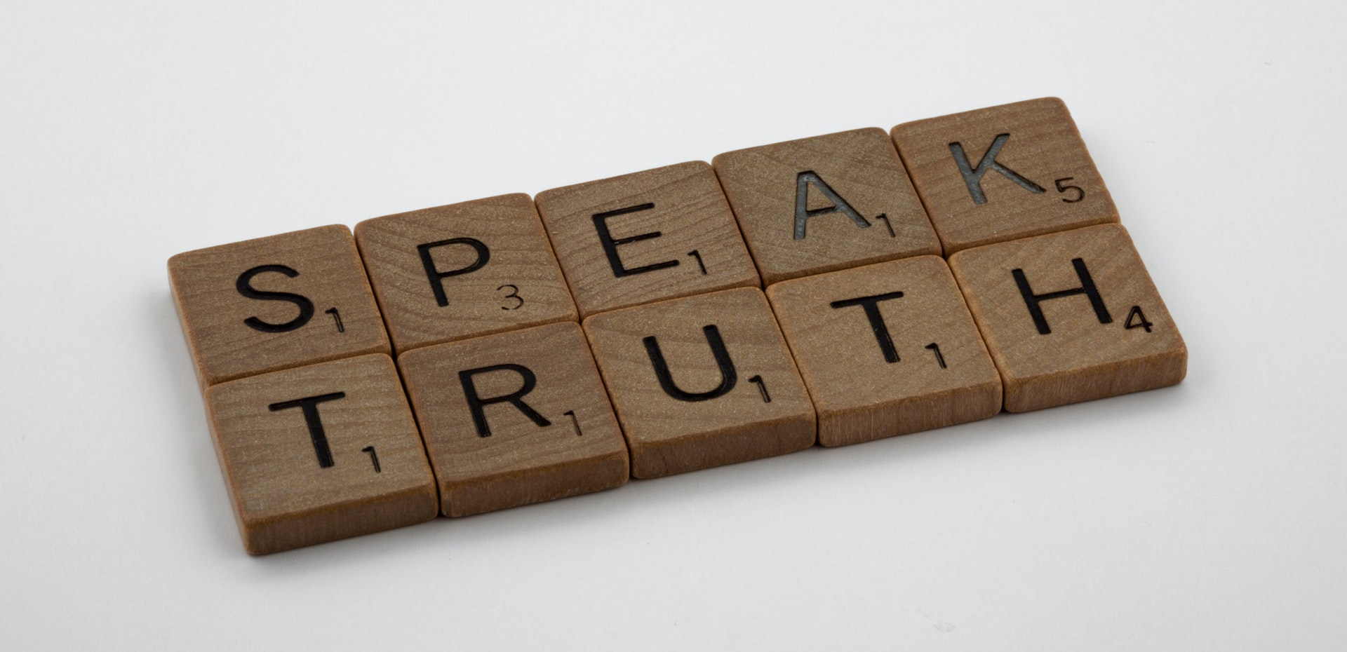 Speak Truth spelled out with Scrabble tiles